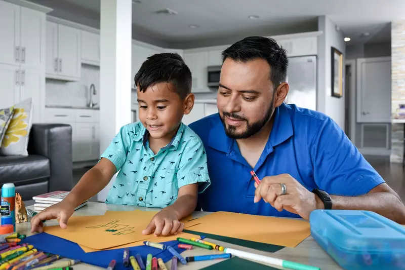 Man with his son coloring