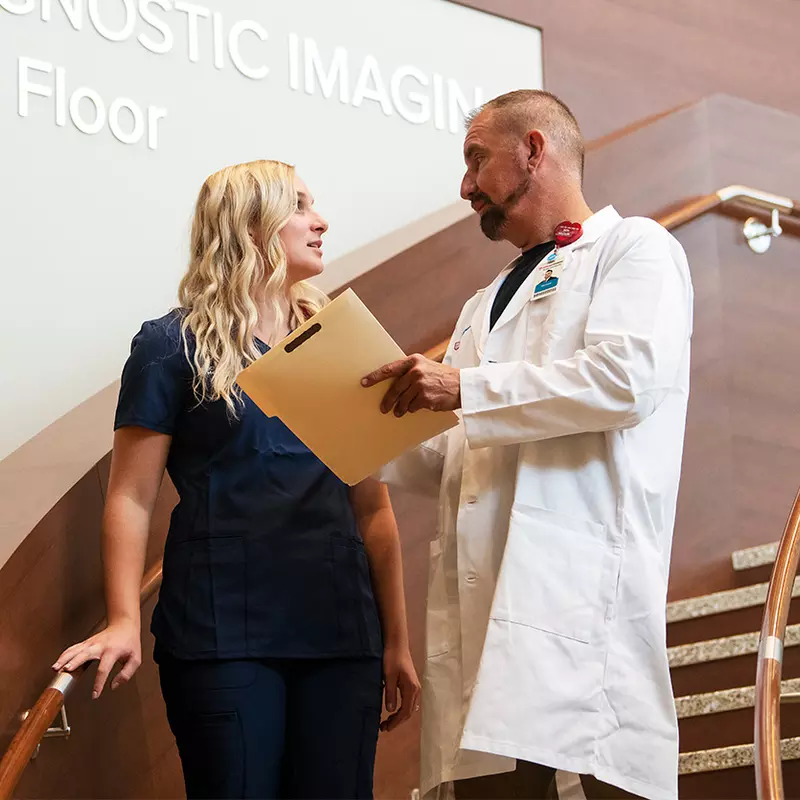 Doctor Giving Nurse Instructions for Patient